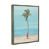 Djevojka Stupell Industries naslonjena na obalno slikanje Palm Tree -a sivi floater uokvireni umjetnički print